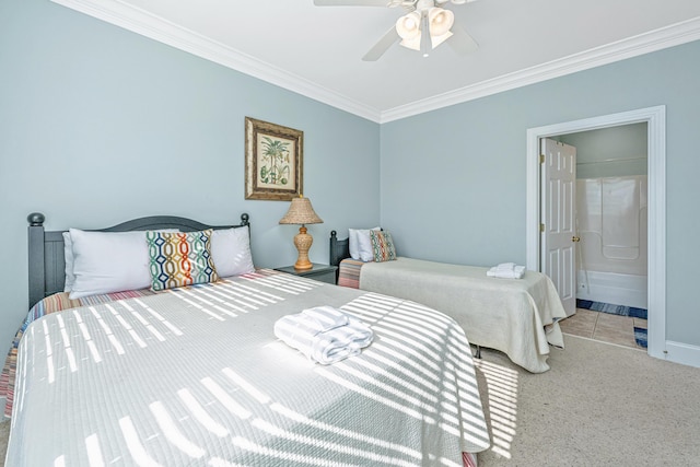 bedroom featuring light carpet, ensuite bathroom, ceiling fan, and ornamental molding