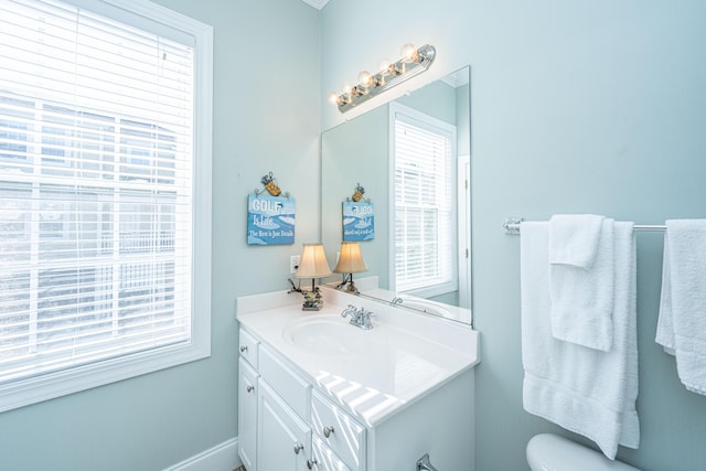 bathroom featuring vanity and toilet