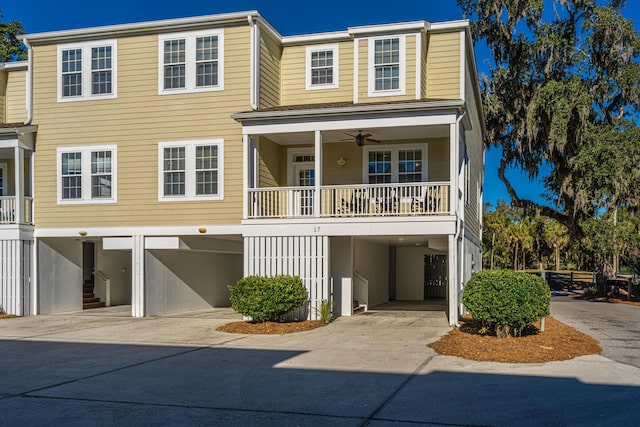 view of front facade featuring ceiling fan and a carport