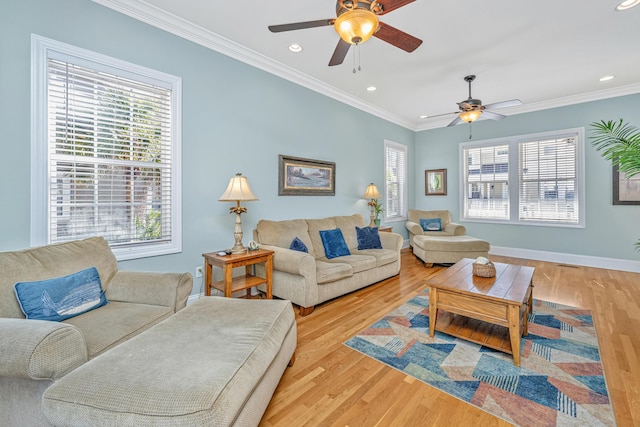 living room featuring crown molding, ceiling fan, and light hardwood / wood-style floors