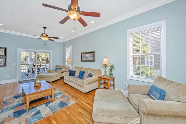 living room with light wood-type flooring, ceiling fan, and ornamental molding