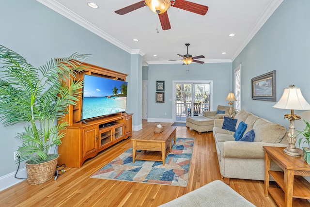 living room featuring ceiling fan, ornamental molding, and light wood-type flooring