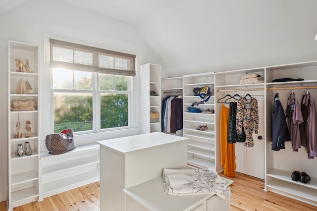 spacious closet featuring lofted ceiling and light wood-type flooring