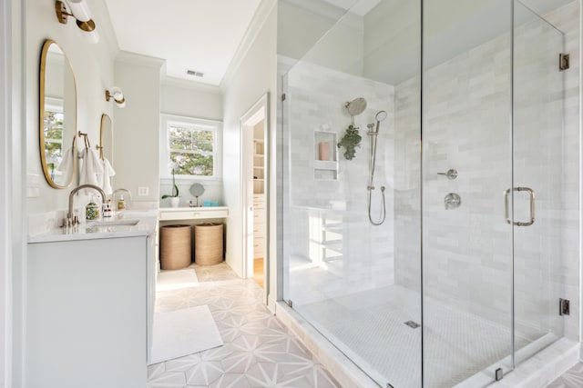 bathroom with a stall shower, crown molding, and vanity