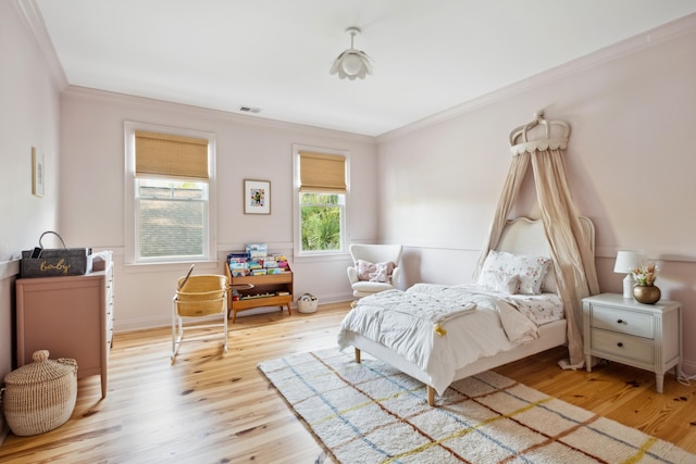 bedroom featuring crown molding and wood finished floors