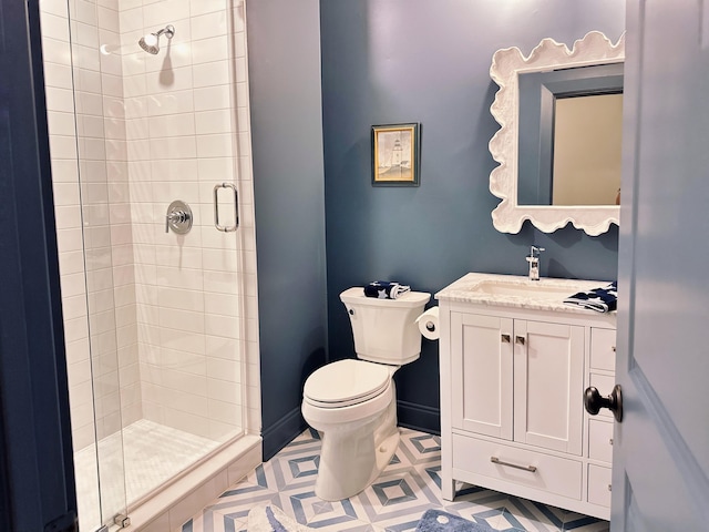 bathroom featuring a stall shower, toilet, and vanity