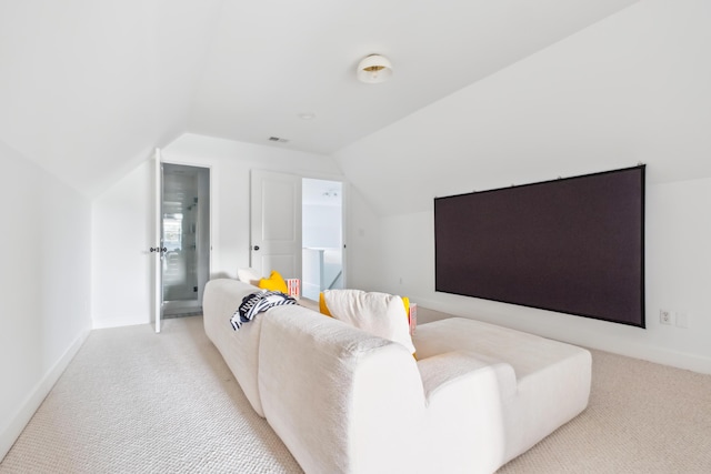 cinema room featuring carpet floors, lofted ceiling, and baseboards