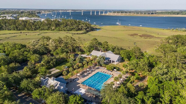 aerial view of a large body of water, a pool area, and a notable bridge