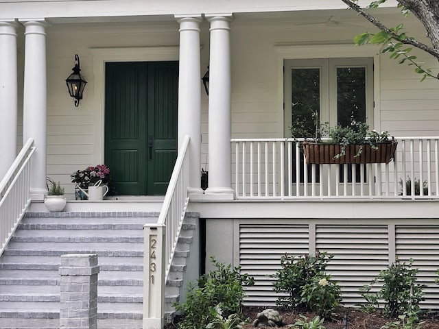 entrance to property featuring french doors and a porch