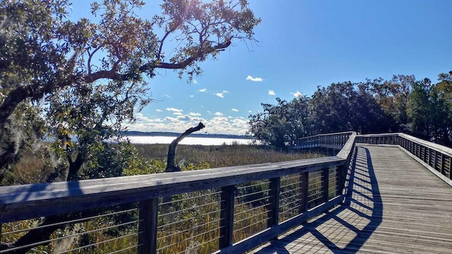 wooden terrace featuring a water view