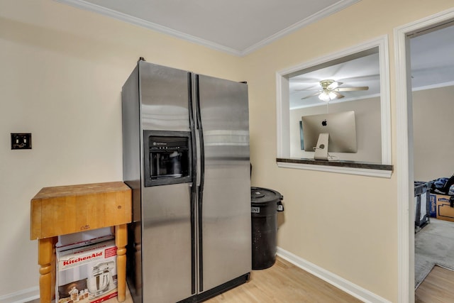 kitchen with stainless steel fridge, light hardwood / wood-style floors, ceiling fan, and crown molding