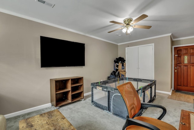 carpeted office with ceiling fan and crown molding