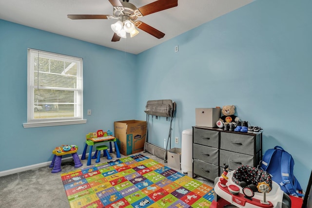 playroom with ceiling fan and light colored carpet