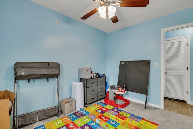 game room featuring ceiling fan and light carpet