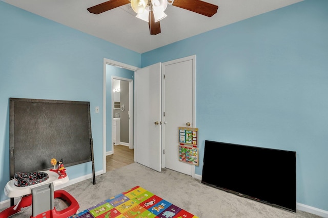 rec room featuring light colored carpet and ceiling fan