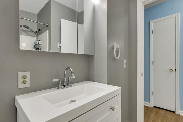 bathroom with hardwood / wood-style floors and vanity