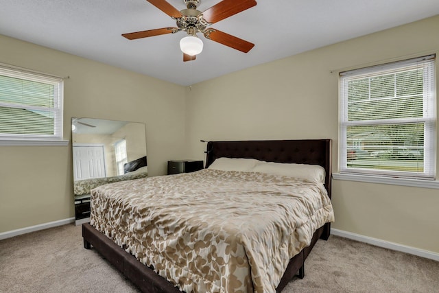 bedroom featuring ceiling fan and light colored carpet