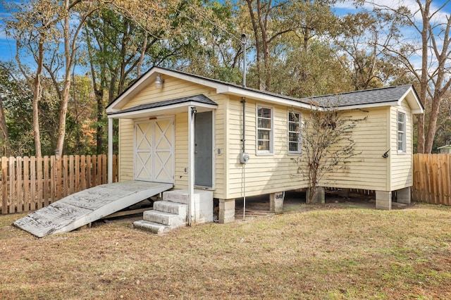 view of outdoor structure featuring a lawn