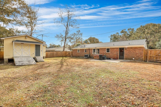 view of yard with a patio area, a storage shed, and central air condition unit