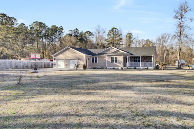 ranch-style house with a garage, covered porch, and a front yard