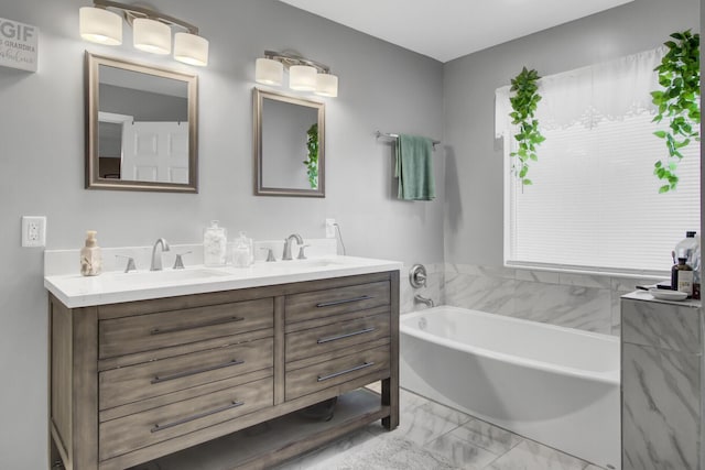 bathroom with vanity and a bath