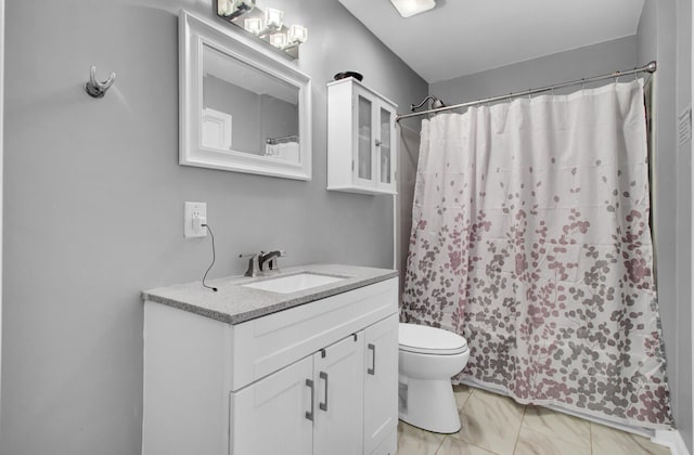 bathroom featuring vanity, toilet, and a shower with shower curtain