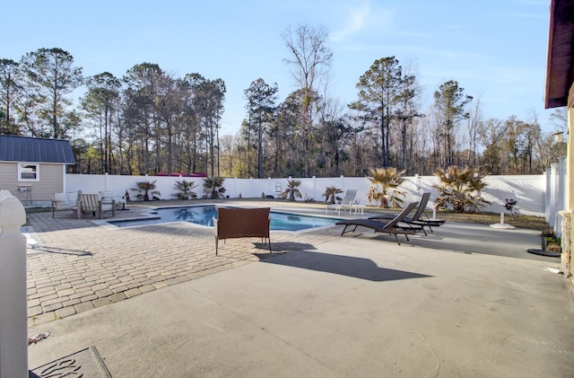 view of swimming pool with a patio area