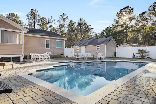 view of swimming pool featuring an outdoor structure and a patio area