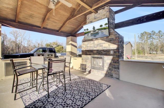 view of patio / terrace featuring a gazebo, ceiling fan, exterior bar, and exterior kitchen