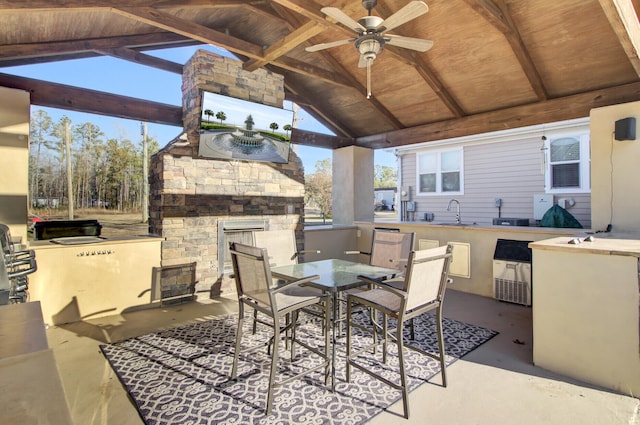 view of patio / terrace featuring a gazebo, ceiling fan, and a large fireplace