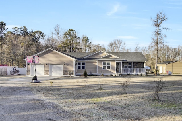 ranch-style house with a garage and covered porch