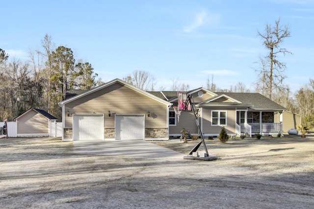 view of front of home featuring a porch and a garage