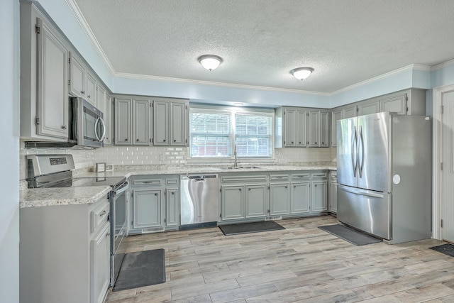 108 Reardon St, Moncks Corner, SC 29461 - kitchen with stainless steel appliances, a textured ceiling, gray cabinets, ornamental molding, and backsplash