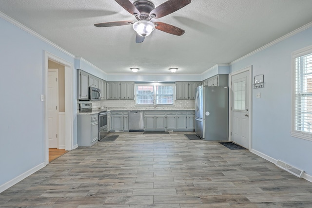 108 Reardon St, Moncks Corner, SC 29461 - kitchen with gray cabinetry, appliances with stainless steel finishes, a textured ceiling, tasteful backsplash, and ceiling fan
