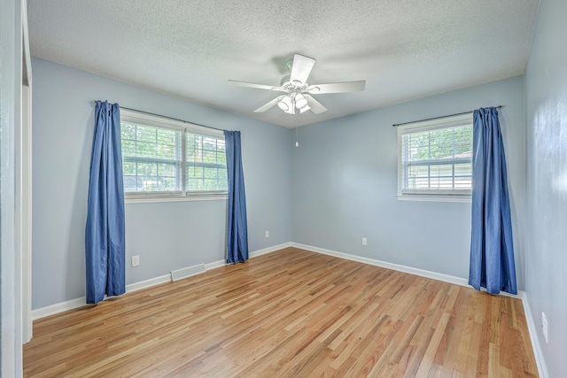 108 Reardon St, Moncks Corner, SC 29461 - unfurnished room featuring healthy amount of natural light, light wood-type flooring, a textured ceiling, and a ceiling fan