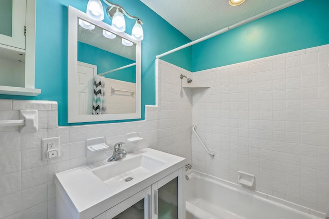 108 Reardon St, Moncks Corner, SC 29461 - bathroom featuring shower / bathtub combination with curtain, vanity, tile walls, and a textured ceiling