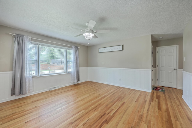 108 Reardon St, Moncks Corner, SC 29461 - spare room featuring wood finished floors, wainscoting, a textured ceiling, and ceiling fan