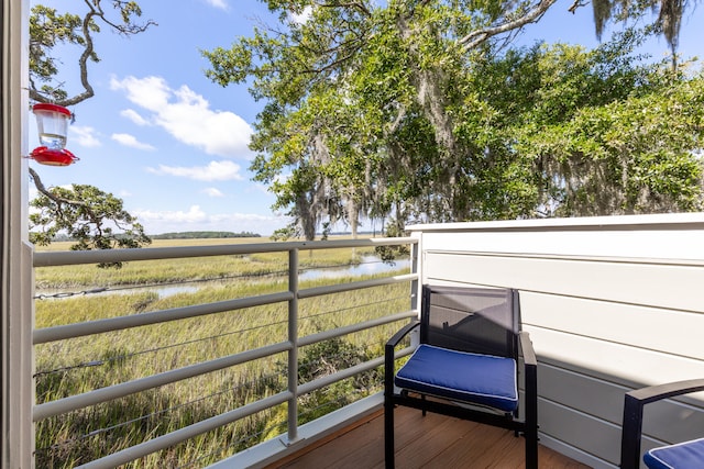 wooden terrace featuring a water view