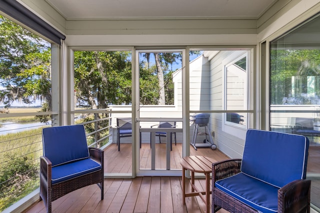 sunroom / solarium with a healthy amount of sunlight and a water view