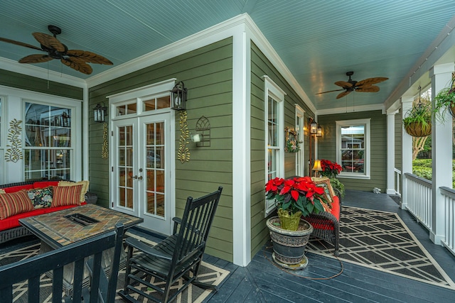 sunroom / solarium with ceiling fan and french doors