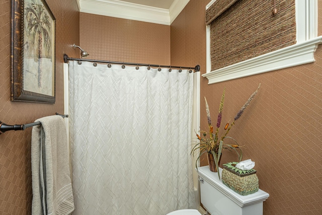 bathroom with toilet and crown molding