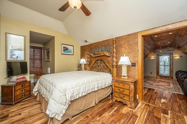 bedroom featuring hardwood / wood-style flooring, ceiling fan, and lofted ceiling