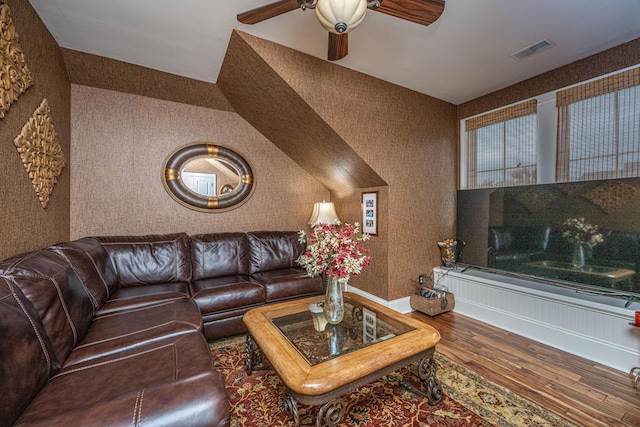 living room featuring hardwood / wood-style flooring and ceiling fan