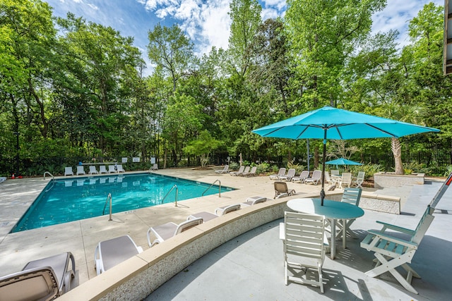 view of swimming pool with a patio area