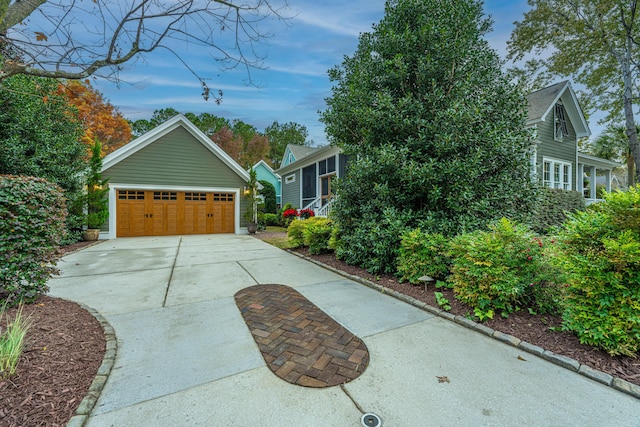 view of side of home featuring an outbuilding and a garage