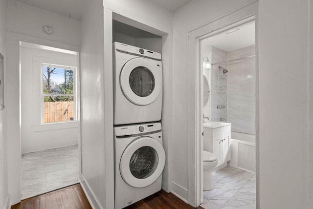 washroom with stacked washer / dryer