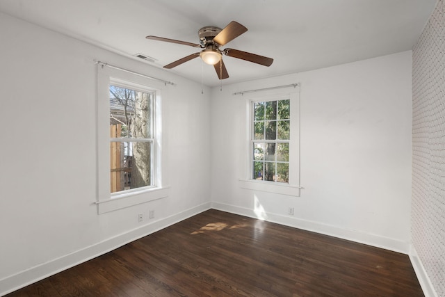 empty room featuring dark hardwood / wood-style floors and ceiling fan