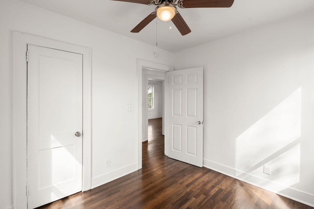 unfurnished bedroom featuring ceiling fan and dark hardwood / wood-style floors