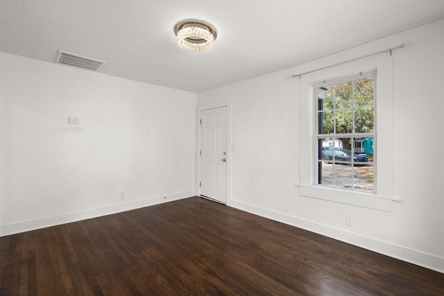 spare room with dark hardwood / wood-style floors