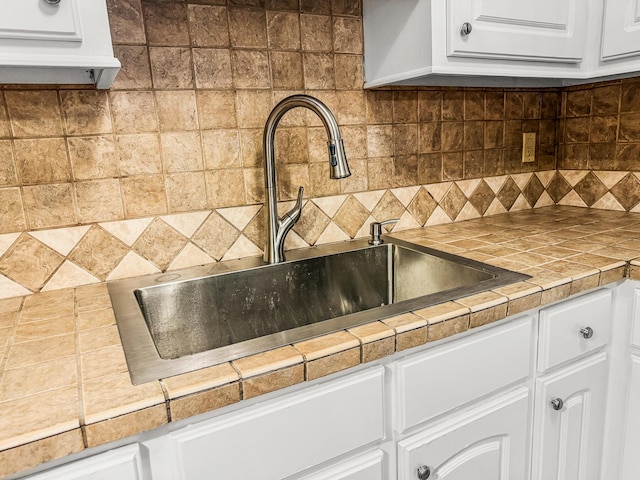 7914 Dutch Ct, North Charleston, SC 29420 - kitchen view of a sink, white cabinets, and backsplash